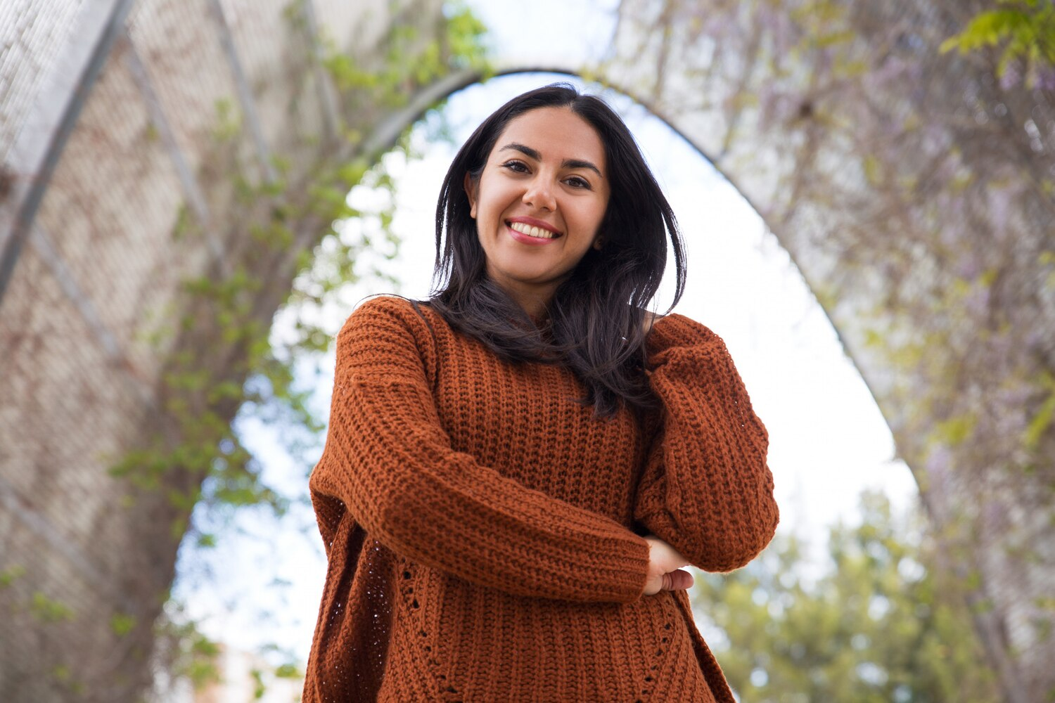 A smiling woman whose market signals are summarised beside her